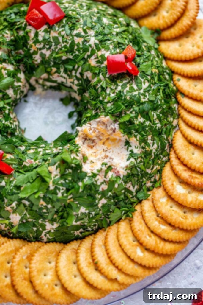 A close-up view of the interior texture of the Bacon Cheese Ball Wreath, showcasing the creamy cheese and pieces of bacon.