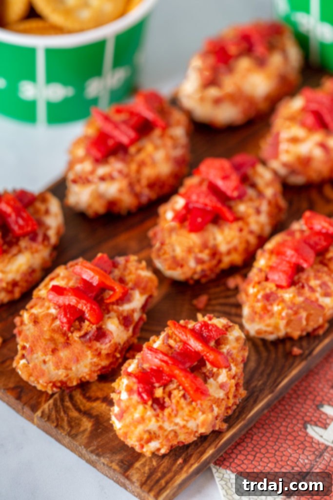 A full serving tray beautifully arranged with chilled Horseradish Cheesy Footballs, garnished with fresh herbs and ready for serving at a festive game day event.