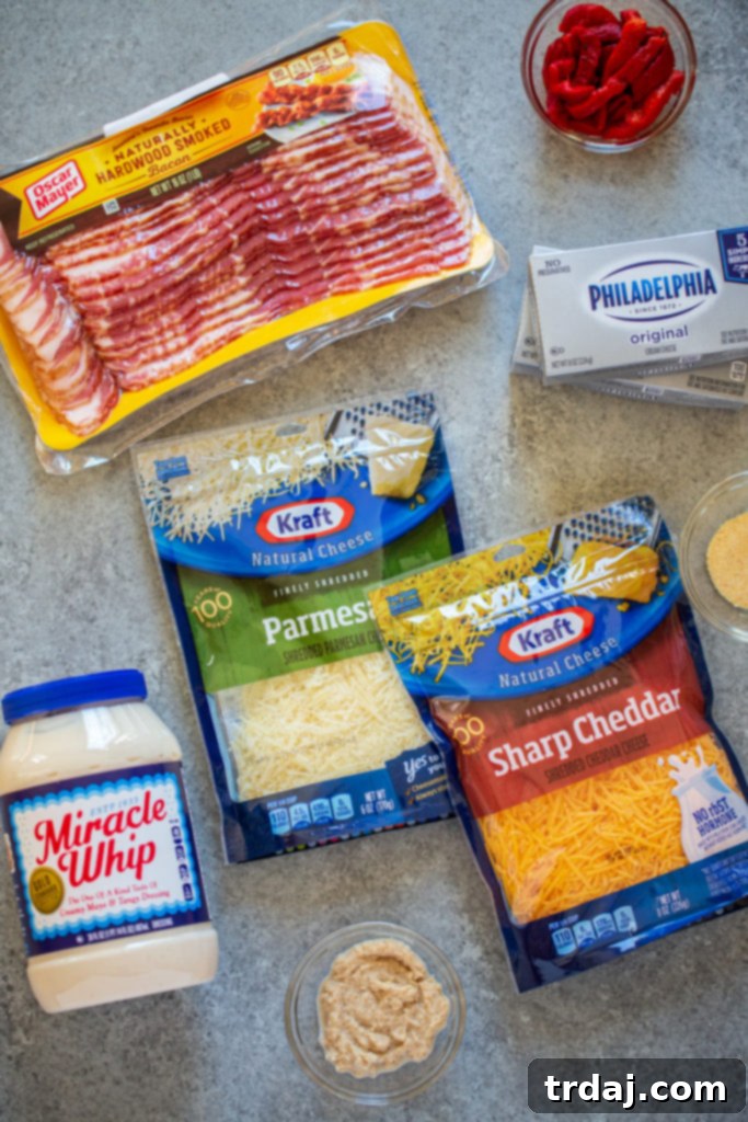 A beautifully arranged selection of fresh ingredients for Horseradish Cheesy Footballs, including cream cheese, bacon, shredded cheddar, Parmesan, horseradish, and pimento, ready for preparation.