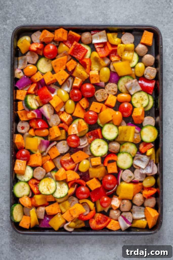 Place chopped vegetables and sauages evenly onto sheet pan