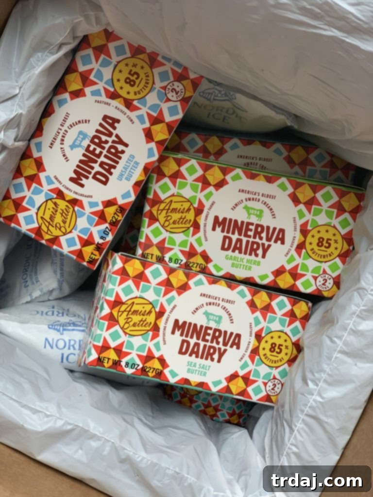 Two blocks of Minerva Dairy butter displayed on a rustic wooden board, emphasizing quality ingredients