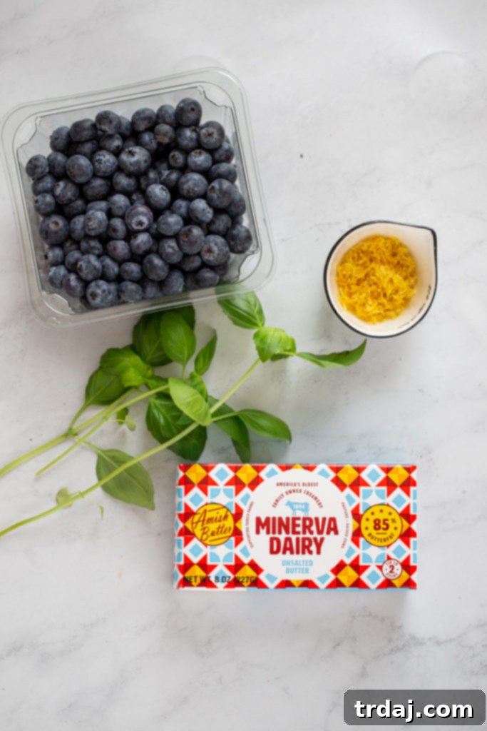 Ingredients for blueberry basil butter: fresh blueberries, basil leaves, lemon, and Minerva Dairy butter