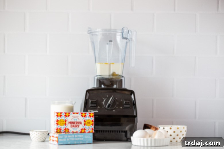 Blender with wet ingredients being prepared for easy popover recipe