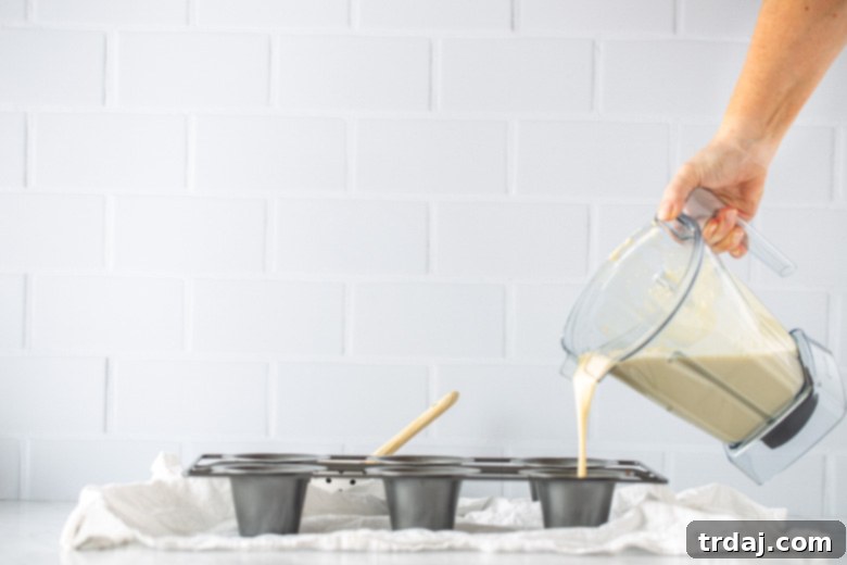 Popover batter being poured into a preheated popover pan