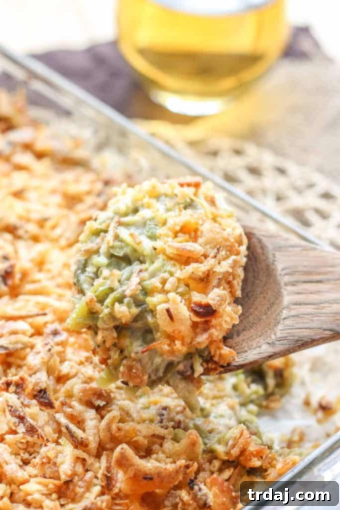 A close-up of The Best Green Bean Casserole featuring tender green beans, rich sauce, and crispy onion topping.
