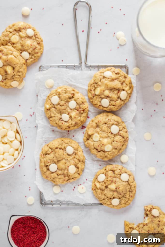 These White Chocolate Cranberry Oatmeal Cookies are soft, chewy and with added health benefits of cranberry seeds making them the BEST recipe! White Chocolate Cranberry Oatmeal Cookies with a glass of milk and bowl of cranberry seeds