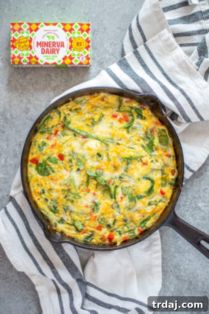 Garden Herb Frittata cooking in a cast iron pan with Minerva Dairy garlic herb butter
