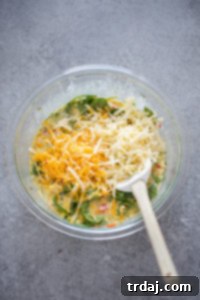 Cooled vegetables, spinach, and cheese folded into the egg mixture