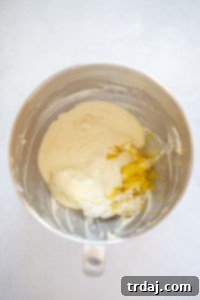 Melted white chocolate, lemon juice, and zest added to the cream cheese mixture in a stand mixer
