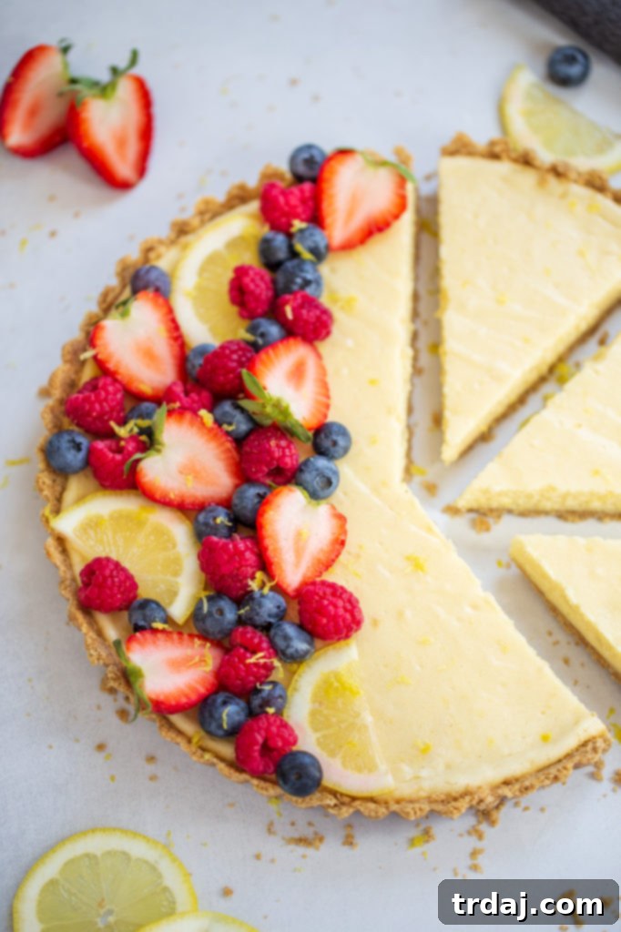 Beautifully decorated White Chocolate Lemon Cheesecake Tart with various fresh berries