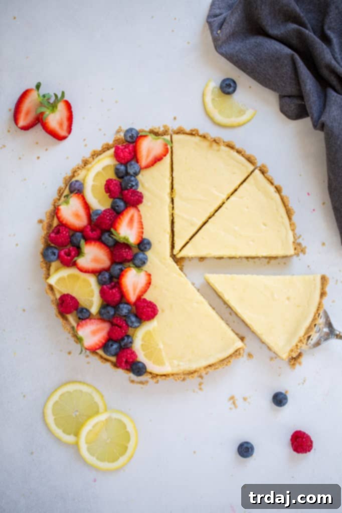 Close-up of the shortbread crust crumbs being pressed into a tart pan