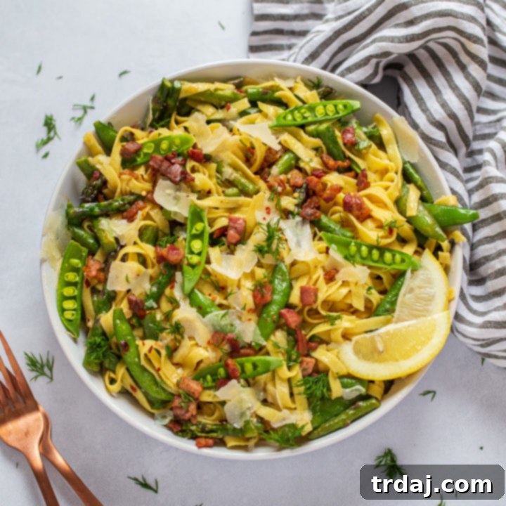 Springtime Lemon Pasta in a bowl with fresh lemon and dill garnish.