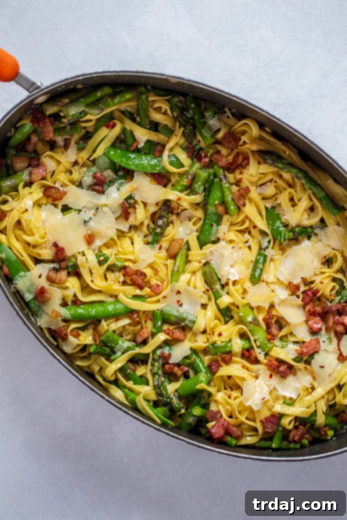 A large skillet filled with Springtime Lemon Pasta, garnished with fresh dill, ready to be served.