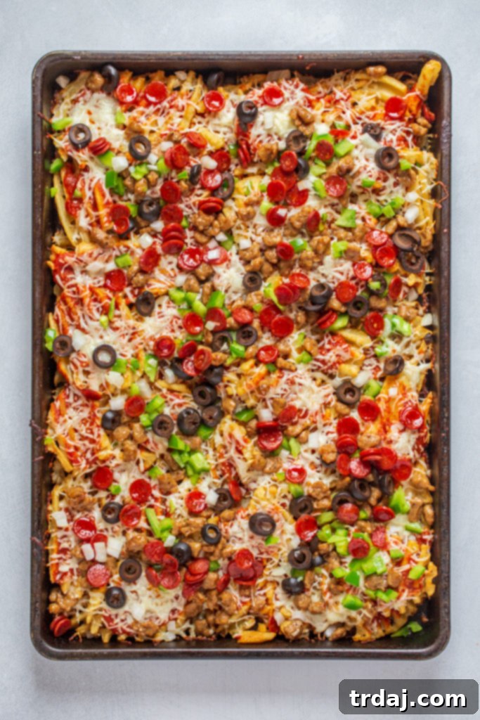 Serving of Sheet Pan Supreme Pizza Fries on a plate