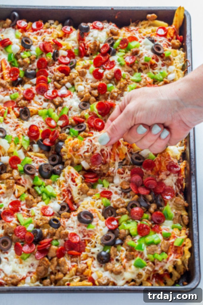 A large serving of Sheet Pan Supreme Pizza Fries, ready to eat