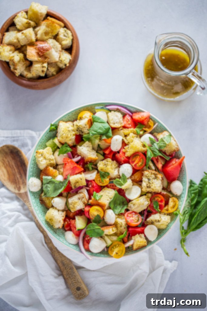 Summer Panzanella Salad with Garlic Butter Croutons on a rustic wooden board, ready for a gathering