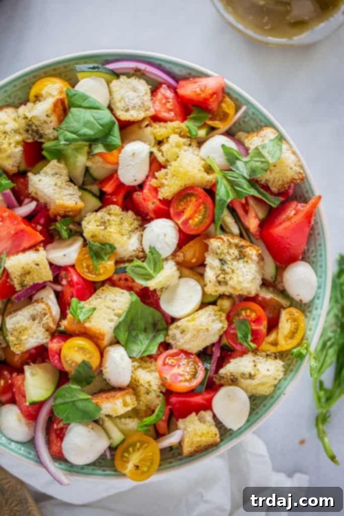 A colorful Panzanella salad featuring fresh vegetables and homemade croutons