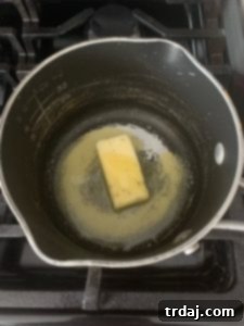 Melting Minerva Garlic Herb butter with olive oil in a saucepan