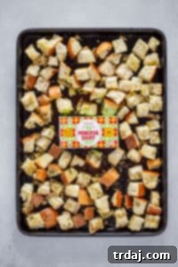 Golden-brown, crispy homemade garlic butter croutons cooling on a baking sheet