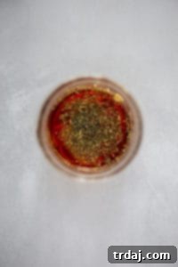 Mason jar filled with vinaigrette ingredients, ready to be shaken