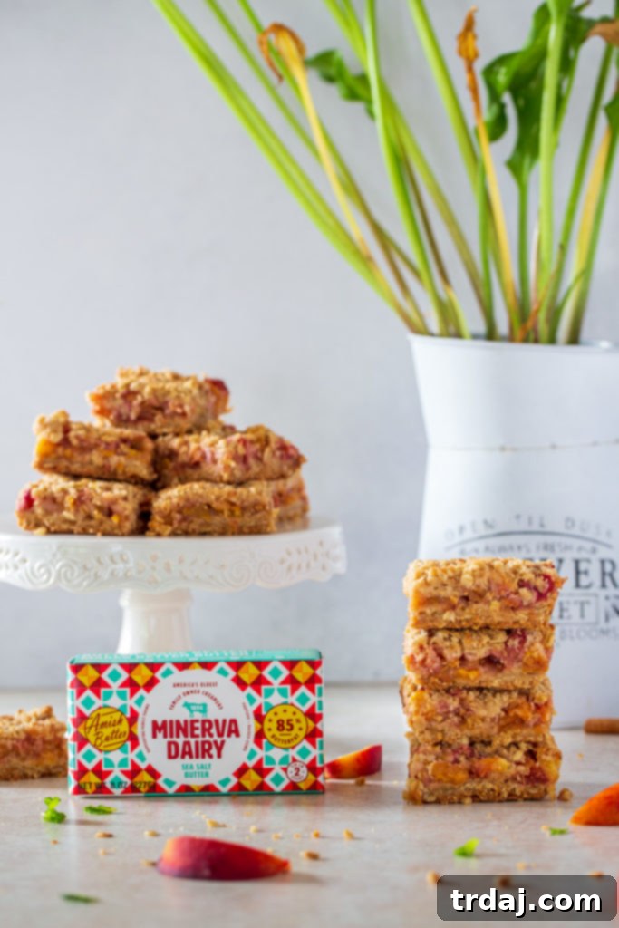 Platter of peach cobbler crumble bars, with a neatly stacked arrangement of bars.