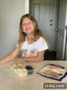Another perspective of a packed lunchbox featuring various snacks and a main dish, emphasizing fresh ingredients.