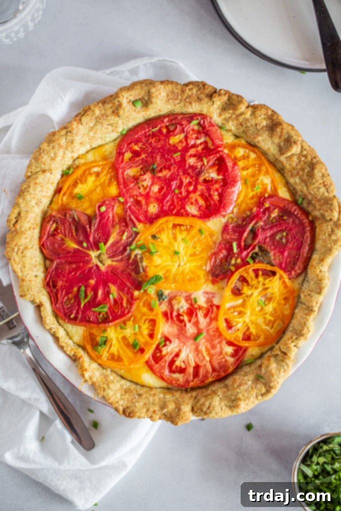 Savory Tomato Pie with a Fresh Herb Crust 2 Vibrant heirloom tomatoes showcasing diverse colors and shapes, ready to be sliced for the pie.