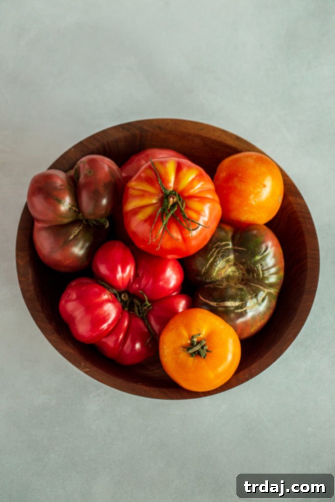 Savory Tomato Pie with a Fresh Herb Crust 3 Close-up of thinly sliced heirloom tomatoes, displaying their beautiful colors and juicy texture.