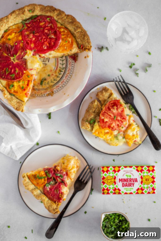 Savory Tomato Pie with a Fresh Herb Crust 6 A slice of tomato pie being served, revealing the layers of crust, cheese, and tomatoes.