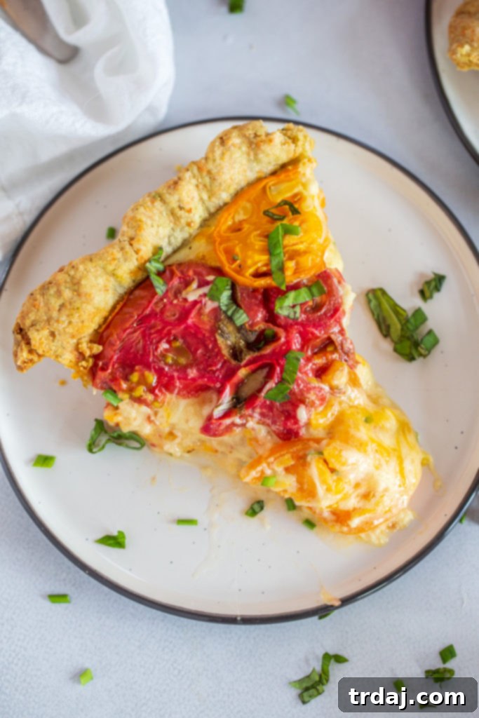 Savory Tomato Pie with a Fresh Herb Crust 7 A close-up of a beautifully cooked slice of tomato pie, showcasing the layers and golden crust.
