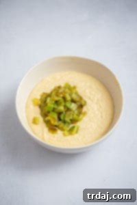 Southwestern Green Chile Cornbread 4 Roasted green chiles folded into the cornbread batter in a bowl, ready for baking.