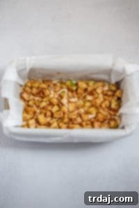 Layering the apple fritter bread: batter, apples, batter, and more apples