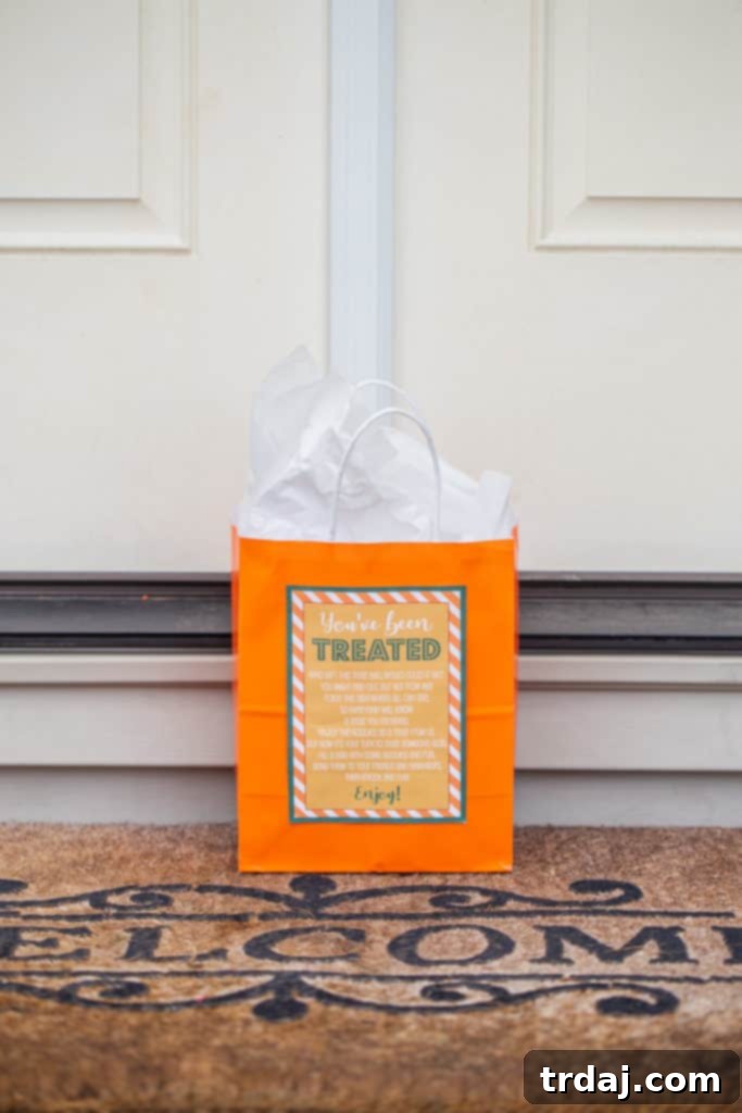 A charming 'You've Been Treated' bag filled with delicious goodies sits at a front door, ready to surprise neighbors.