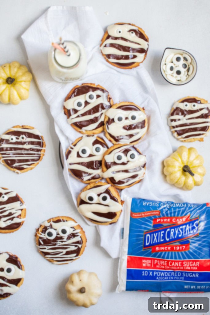 A collection of baking essentials and Dixie Crystals sugar, including a 41-piece silicone bakeware set, Halloween spatulas, and a skull cakelet pan, forming a prize package for the #HalloweenTreatsWeek giveaway.