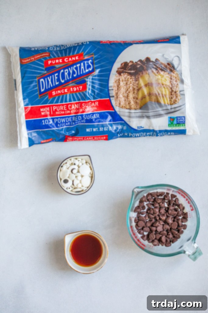 Ingredients for making chocolate ganache and decorating mummy cookies, prominently featuring semi-sweet chocolate chips, heavy cream, powdered sugar, vanilla extract, and playful candy eyeballs.