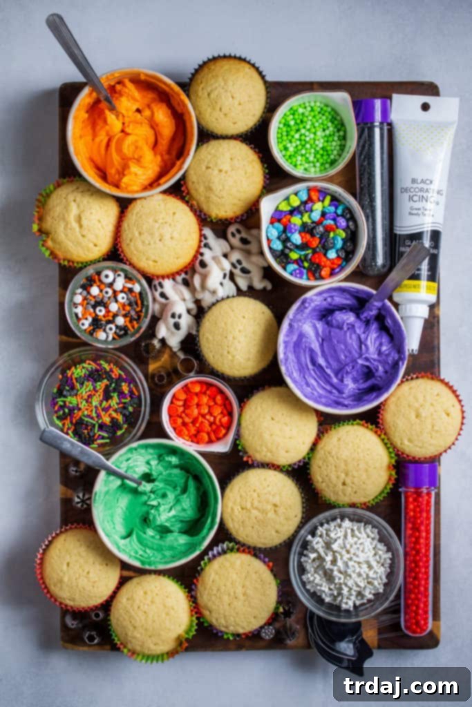 An array of beautifully decorated Halloween cupcakes on a treat board, ready for a party.