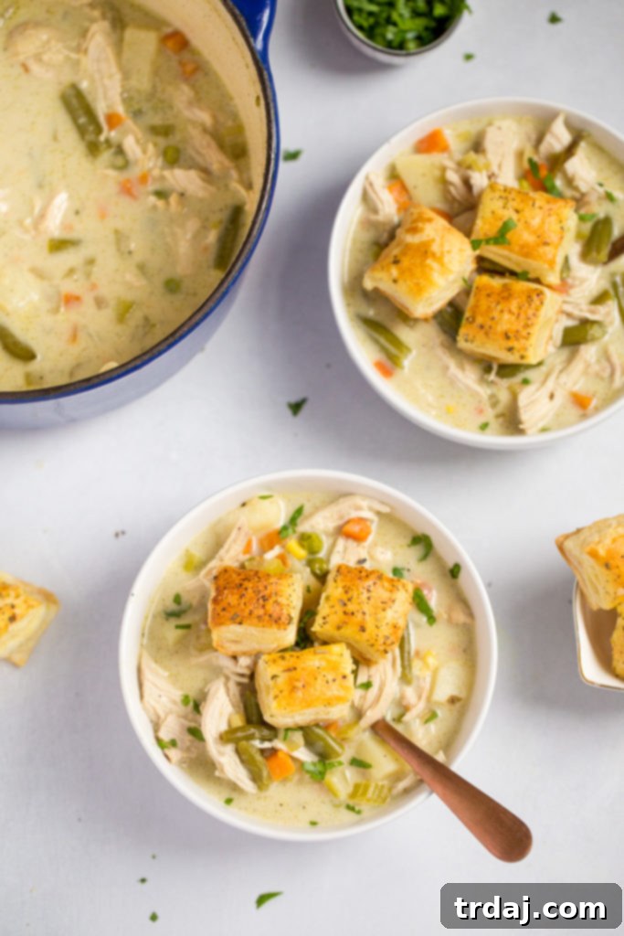 Bowls full of chicken pot pie soup with puff pastry croutons