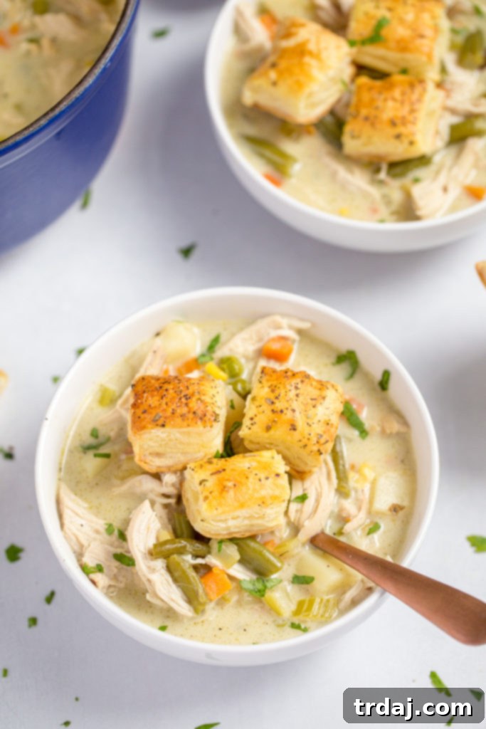 Bowl of creamy chicken pot pie soup with puff pastry croutons