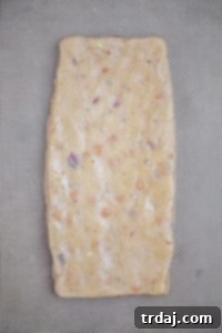Biscotti dough shaped into logs on a baking sheet.