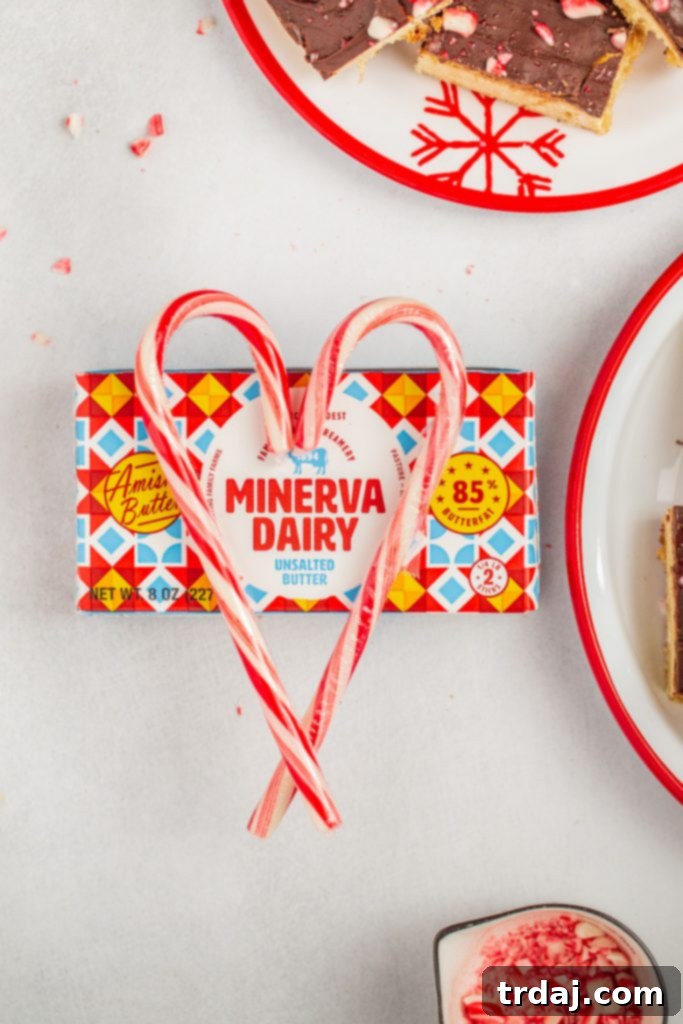 Minerva Dairy Butter, essential for delicious Peppermint Blondies Minerva Dairy Butter stick arranged with candy canes to form a heart shape, highlighting quality ingredients for holiday baking