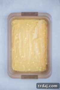 Minty Blondie Bars 5 Blondie batter spread evenly in a baking pan, ready for the oven