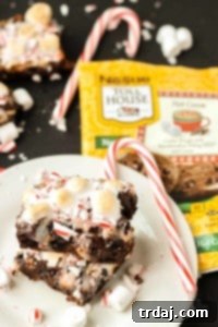 Peppermint Hot Cocoa Cookie Bars, a festive dessert recipe featuring Nestle Toll House Hot Cocoa cookie dough, marshmallows, peppermint, and chocolate.