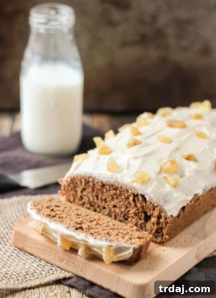 A beautiful shot of a festive Gingerbread Loaf, a perfect low-sugar holiday dessert option, ready to be enjoyed with a warm beverage. Ideal for those looking for healthy holiday baking ideas. | Strawberry Blondie Kitchen
