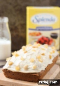 Classic Gingerbread Loaf made with SPLENDA®, a perfect festive dessert. Features aromatic spices, nutmeg cream cheese frosting, and candied ginger. | Strawberry Blondie Kitchen