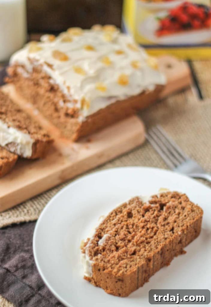 Close-up of a delicious, healthier Gingerbread Loaf with nutmeg cream cheese frosting and candied ginger. A low-calorie, low-sugar holiday dessert made with SPLENDA®. | Strawberry Blondie Kitchen