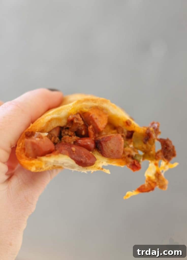 Served Chili Cheese Dog Crescent Ring with condiments on the side, ready for enjoying.