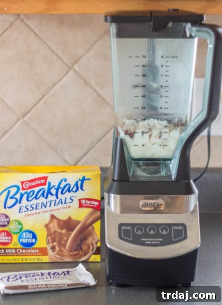 Finished Mocha Coconut Java Carnation Breakfast Shake, topped with coconut flakes and chocolate syrup.