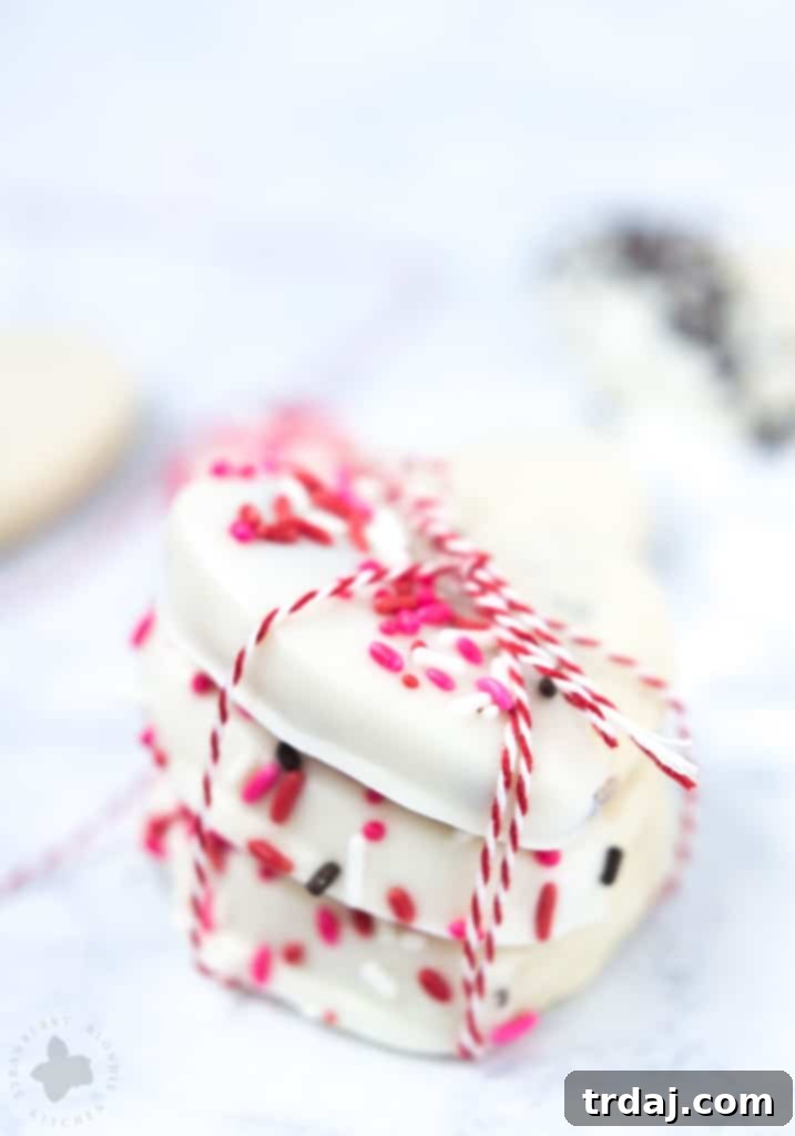 Surprise and delight your Valentine with these White Chocolate Cranberry Shortbread Heart Cookies. Nothing says I love you more than fresh home baked cookies shaped like hearts, dipped in white chocolate and covered in sprinkles!