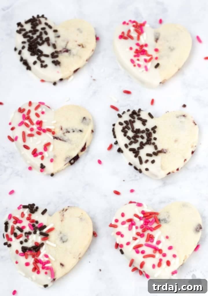 Surprise and delight your Valentine with these White Chocolate Cranberry Shortbread Heart Cookies. Nothing says I love you more than fresh home baked cookies shaped like hearts, dipped in white chocolate and covered in sprinkles!