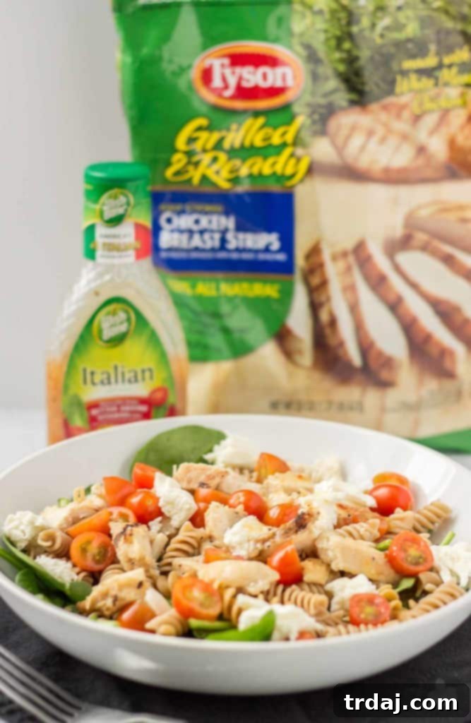 A vibrant, ready-to-eat Layered Chicken Caprese Salad in a Jar, ideal for quick, healthy meals on the go.